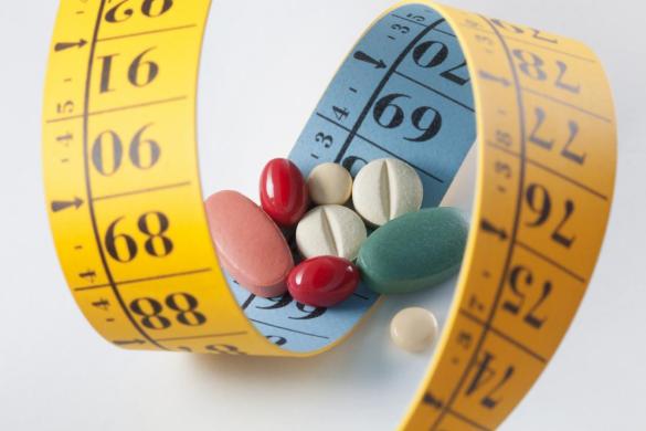 weight-loss-and-diet-pills-surrounded-by-measuring-tape